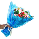 Bouquet of flowers wrapped in blue silent cellophane with a white background - Dependable Expendables